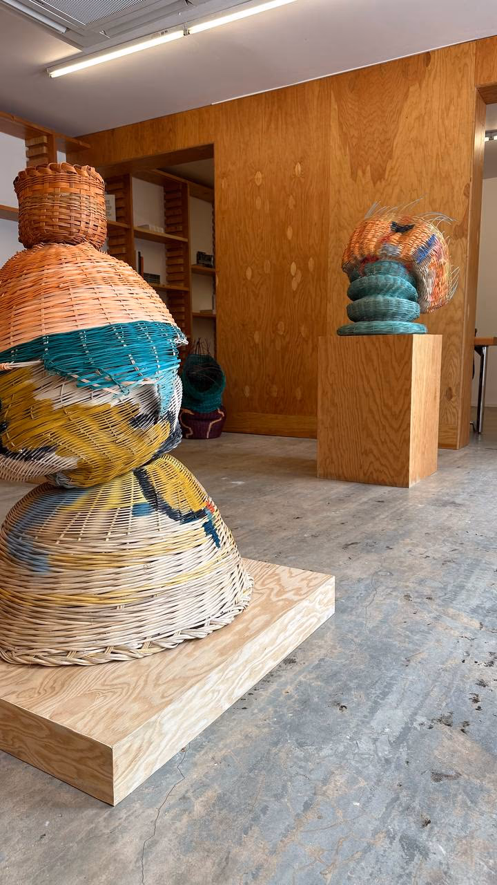 Dee Clements woven-basket sculptures stacked into totemic forms inside the Nina Johnson Gallery in Miami.