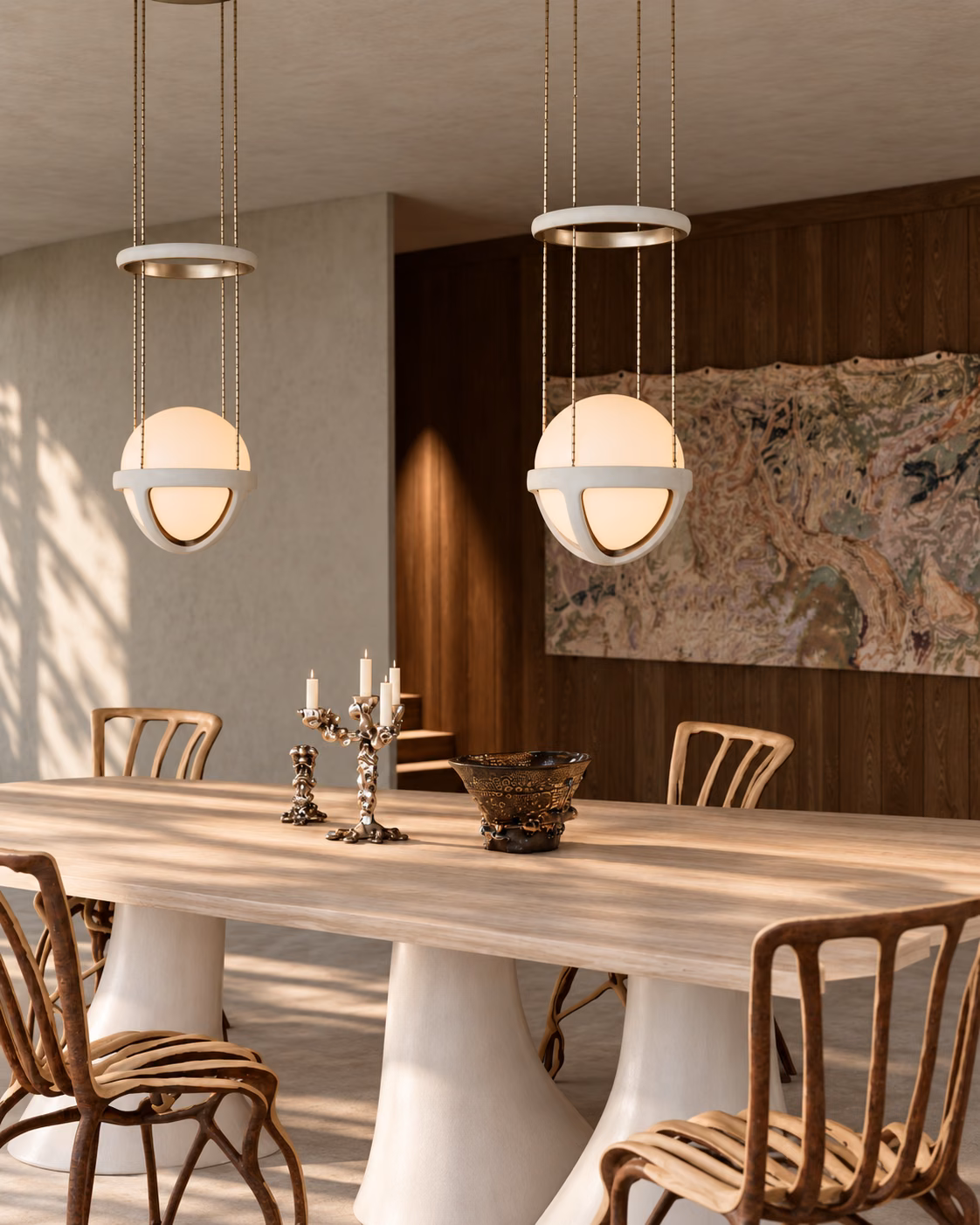 Close-up of the dining area with sculptural fiberglass-based table, Fullgrown tree chairs, and Apparatus pendant lights, set against a dark wooden wall and abstract artwork.