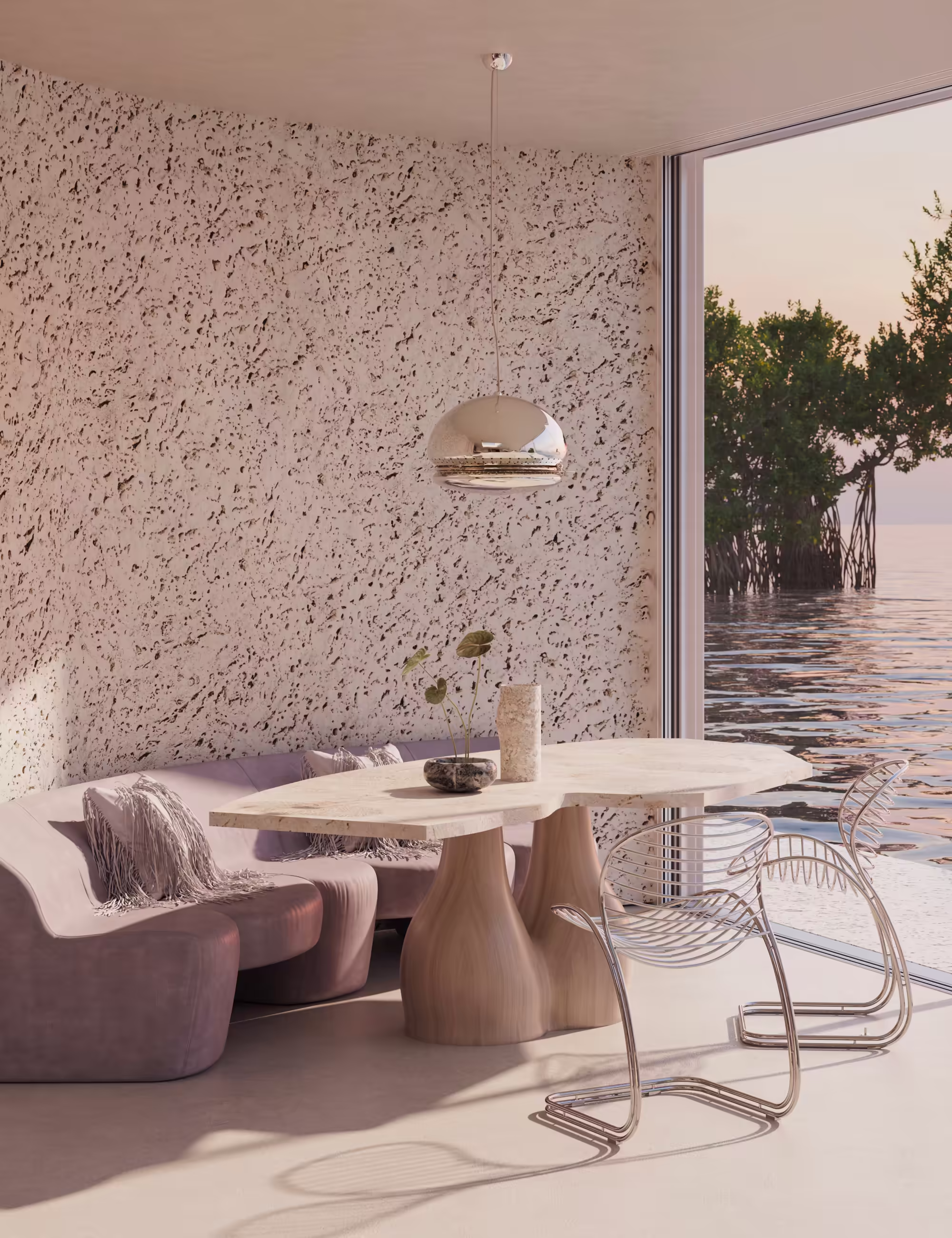 Dining nook with travertine table, pink upholstered banquette, and tubular-steel chairs facing mangroves through a corner window.